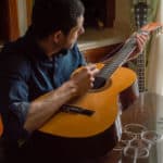 a man changing guitar strings